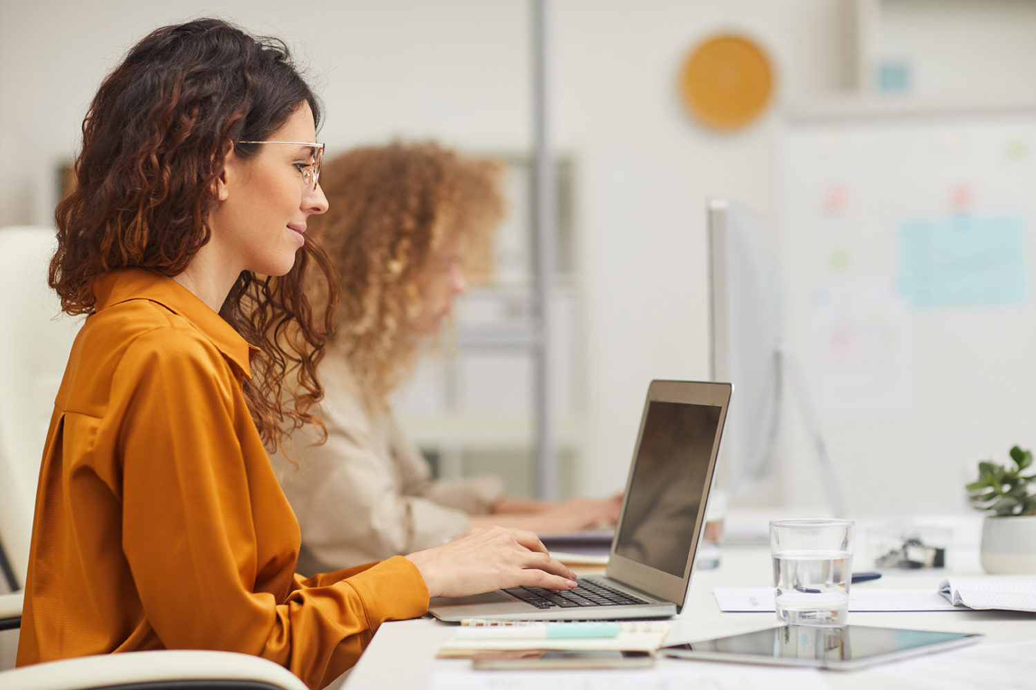 Two Women Working In Office